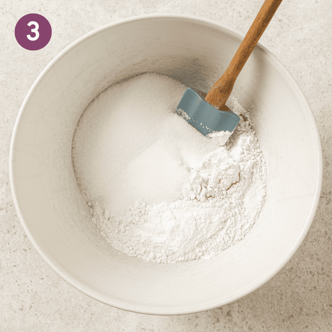 Dry ingredients and silicone spatula in a mixing bowl.