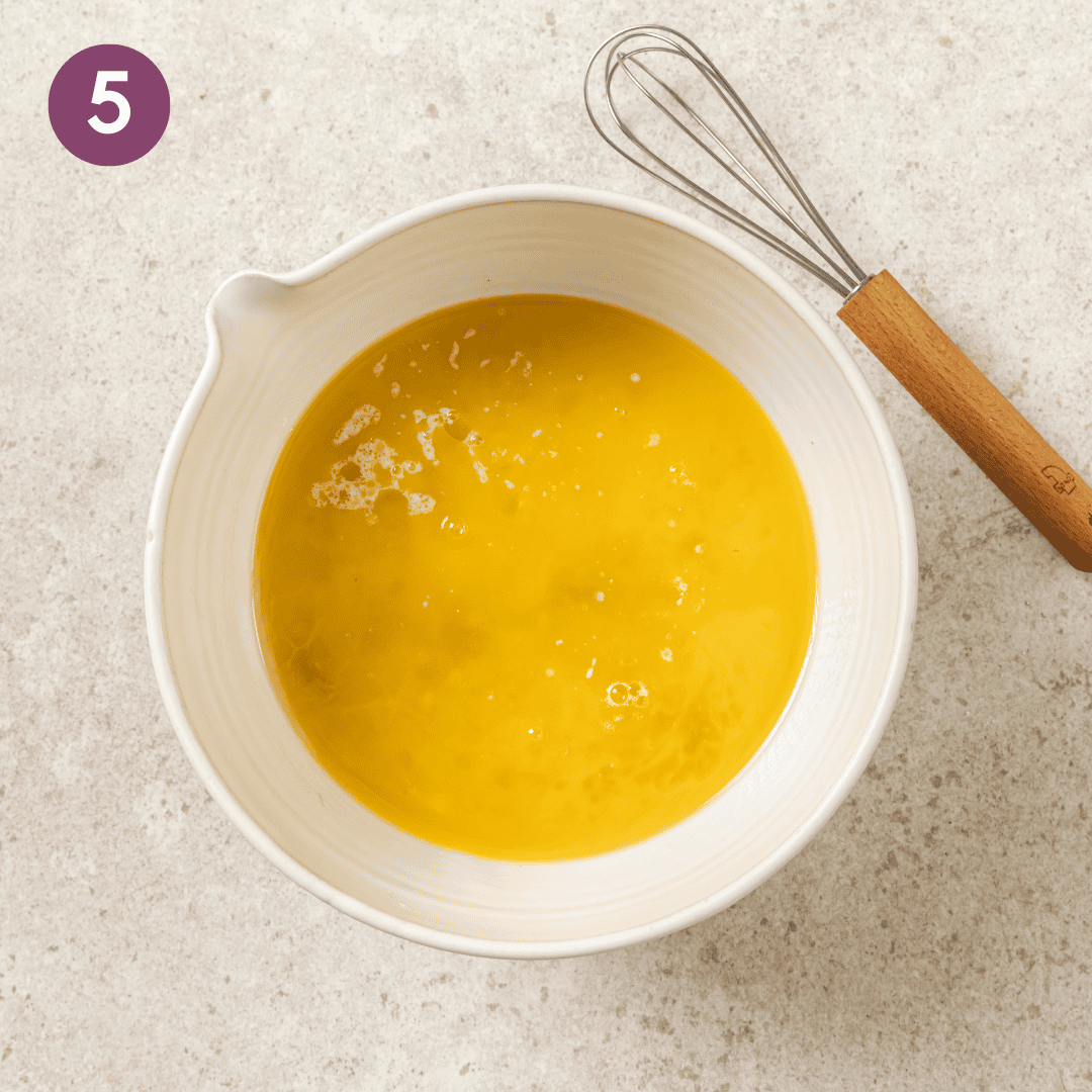 Wet ingredients in a mixing bowl before being mixed.