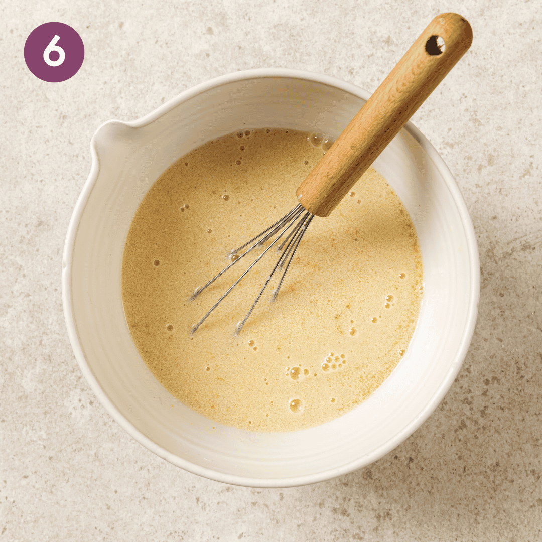 Wet ingredients in a mixing bowl after being mixed.