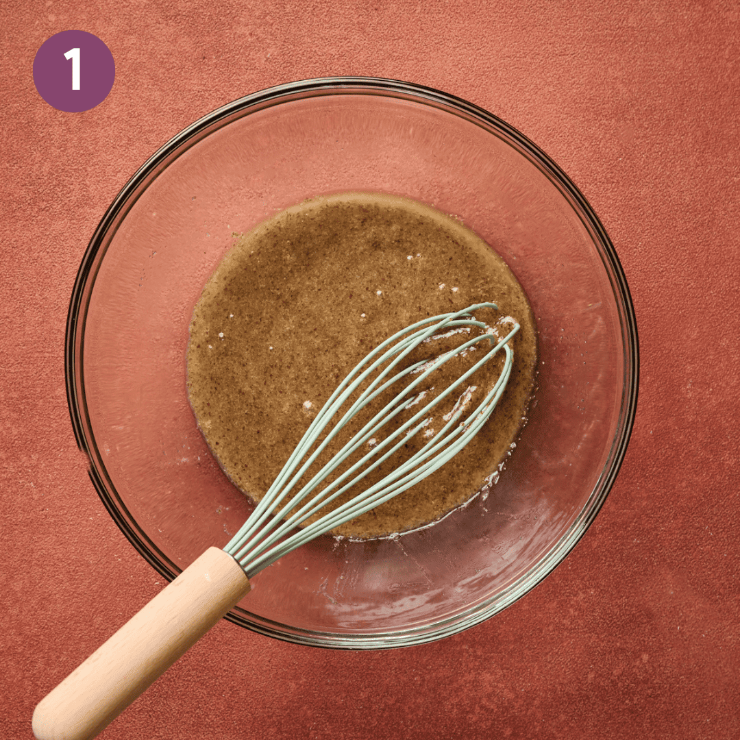 Flax egg and whisk in a glass bowl.