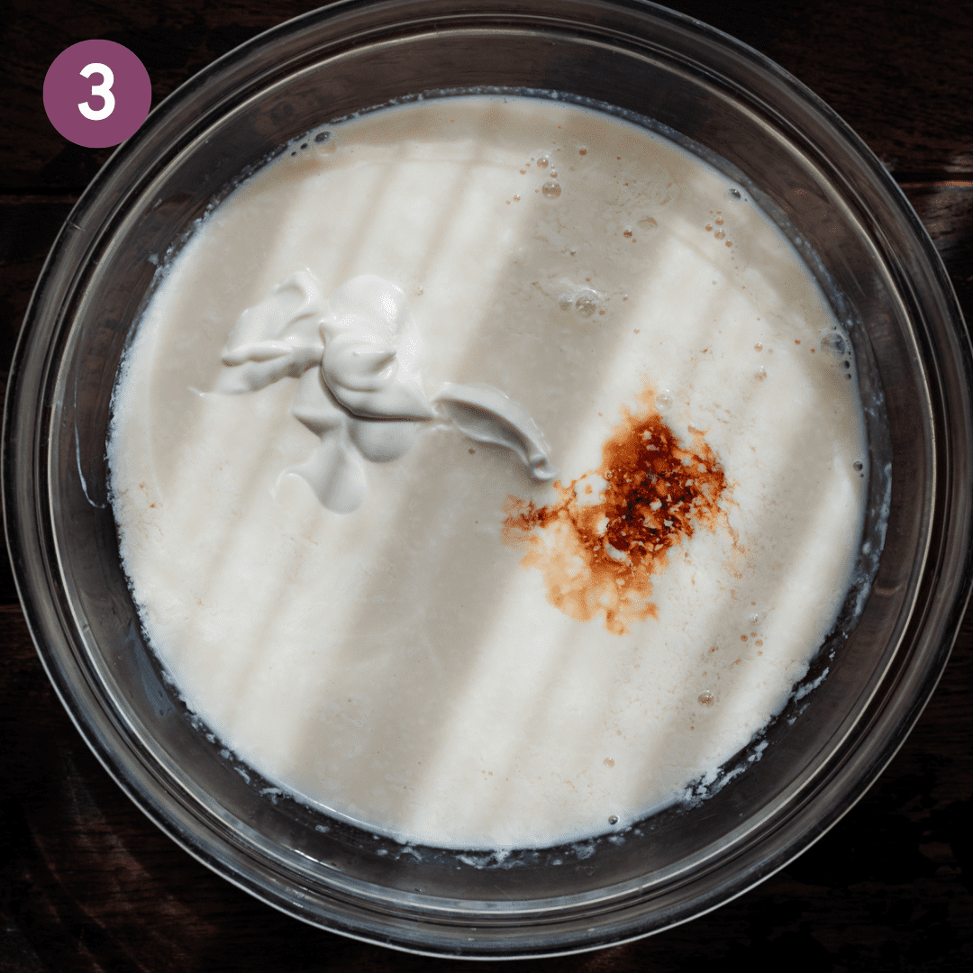 glass bowl with milk, sour cream, vanilla for vegan pancakes.