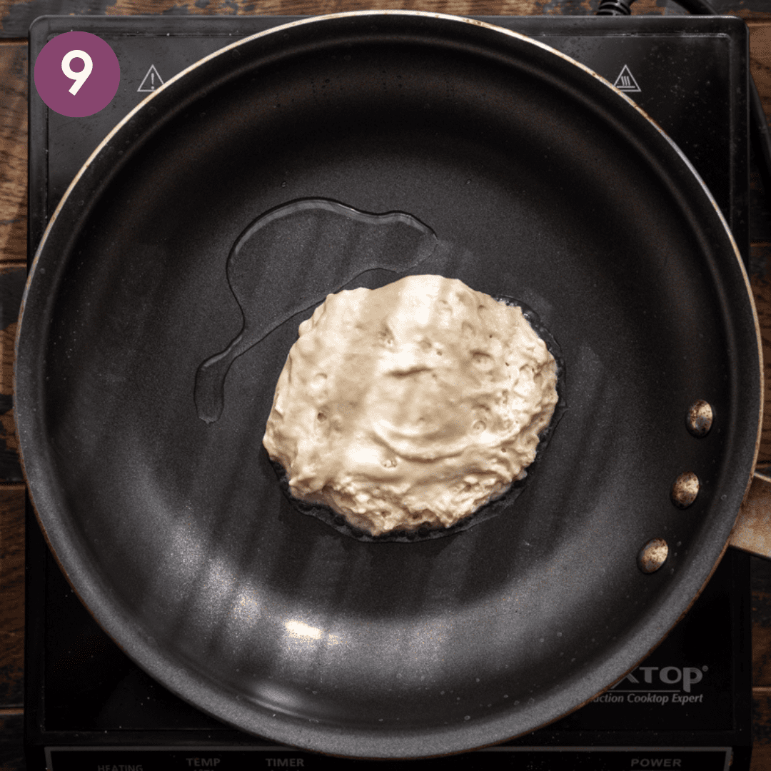 cooking a vegan pancake in a black skillet.