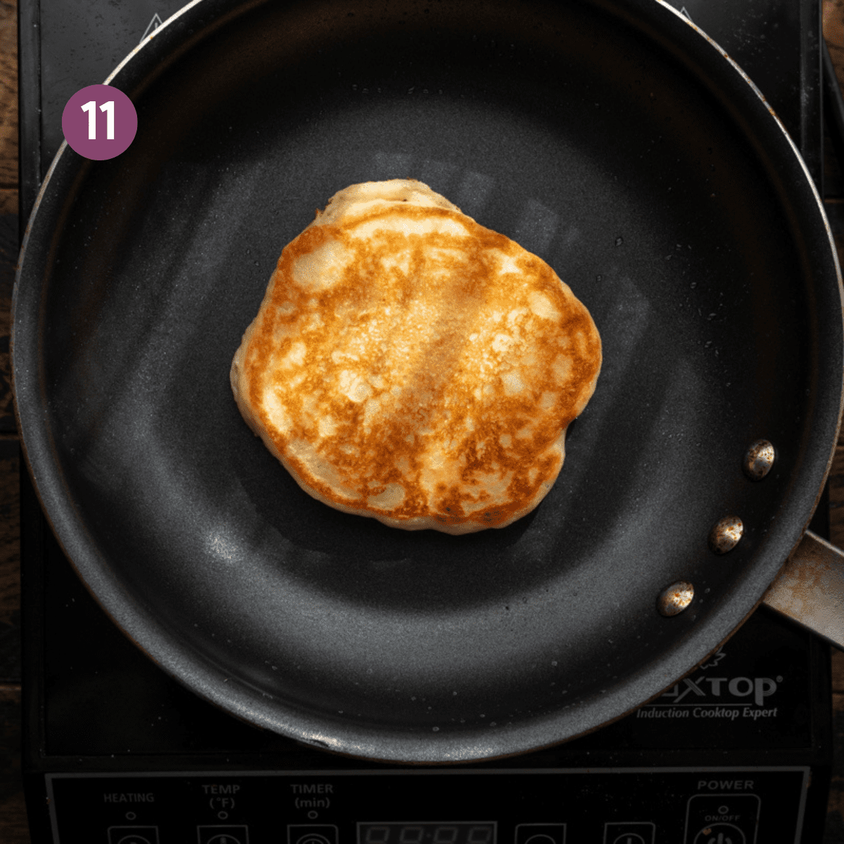 crispy browned vegan pancake in a black frying pan.