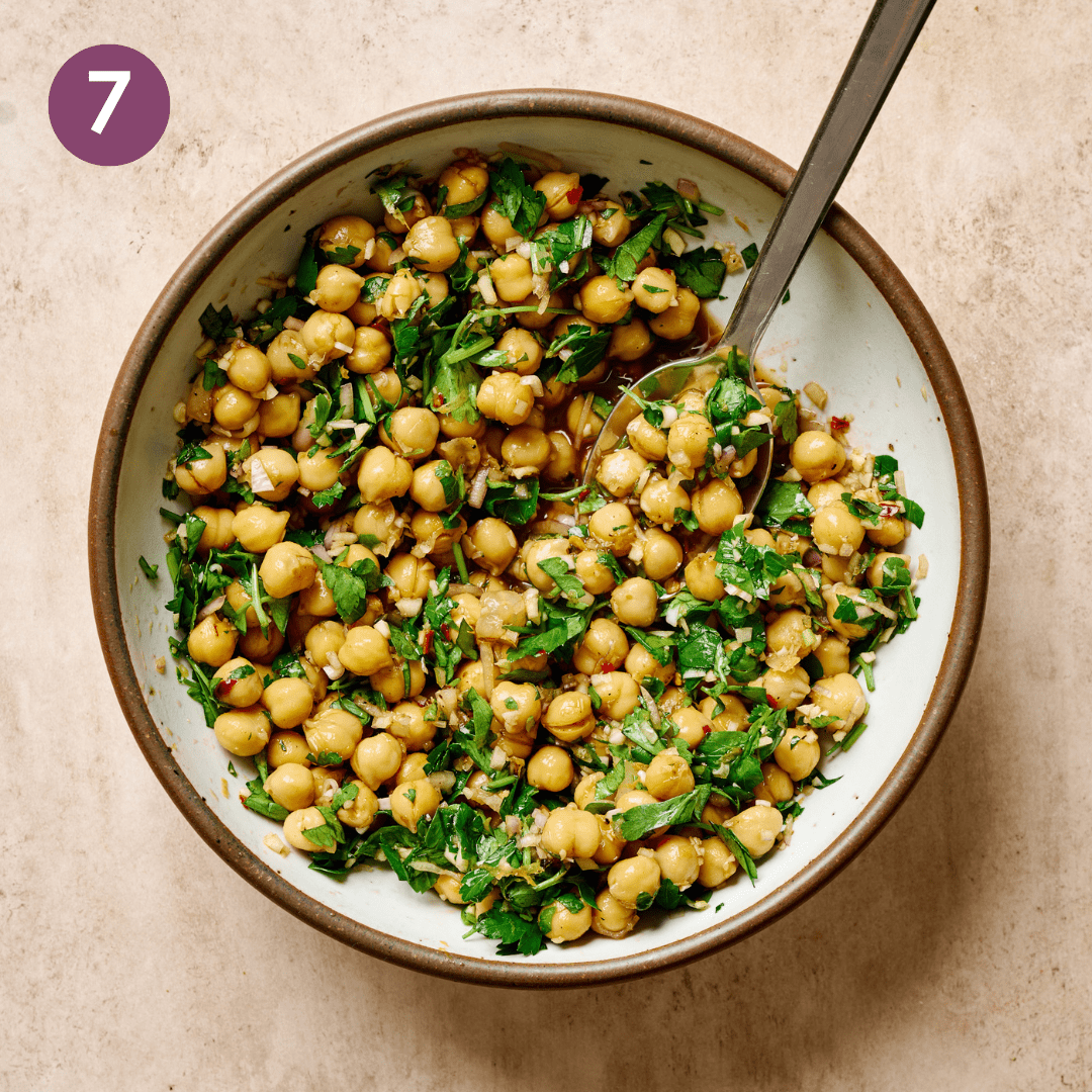 Marinated chickpea ingredients in a bowl after being combined.